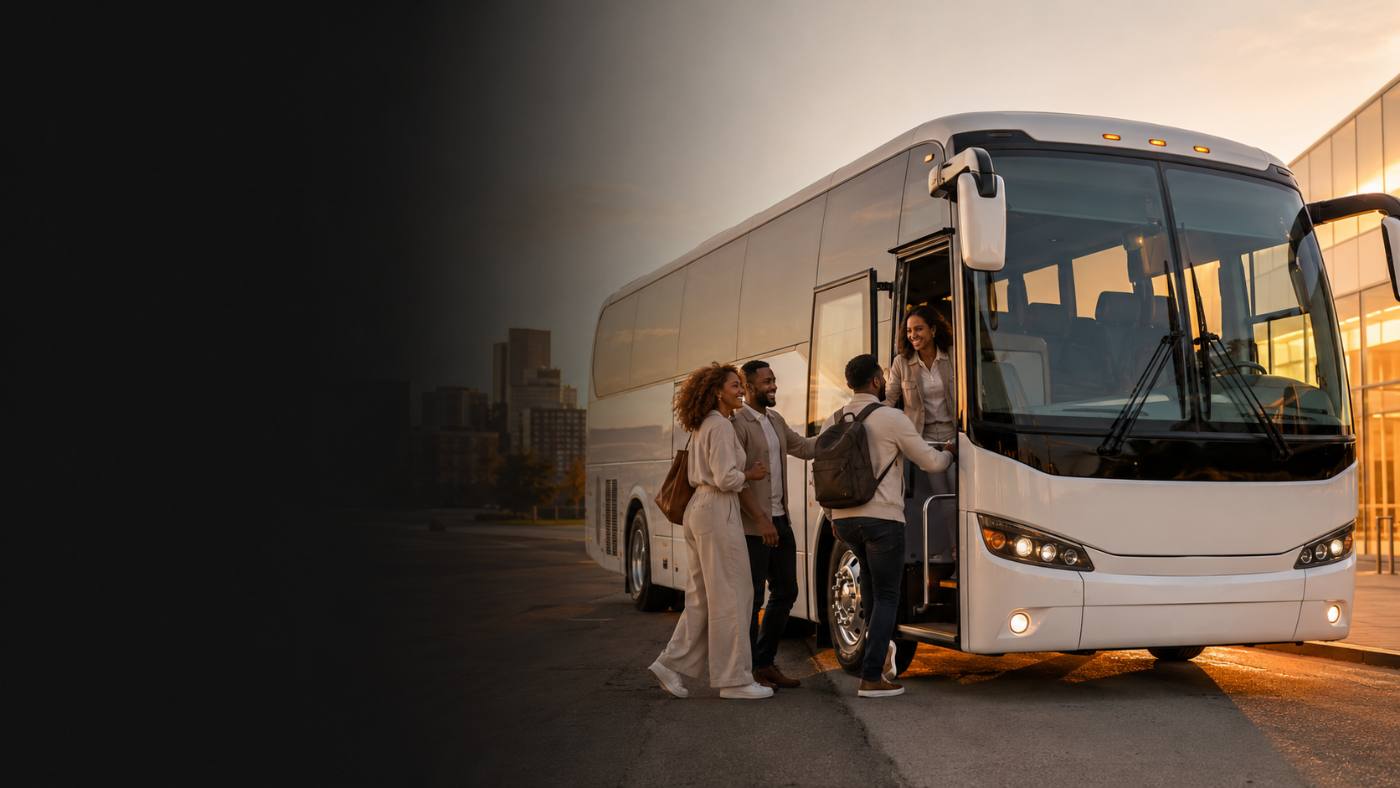 Koladera luxury charter coach on the road at dusk with a city skyline